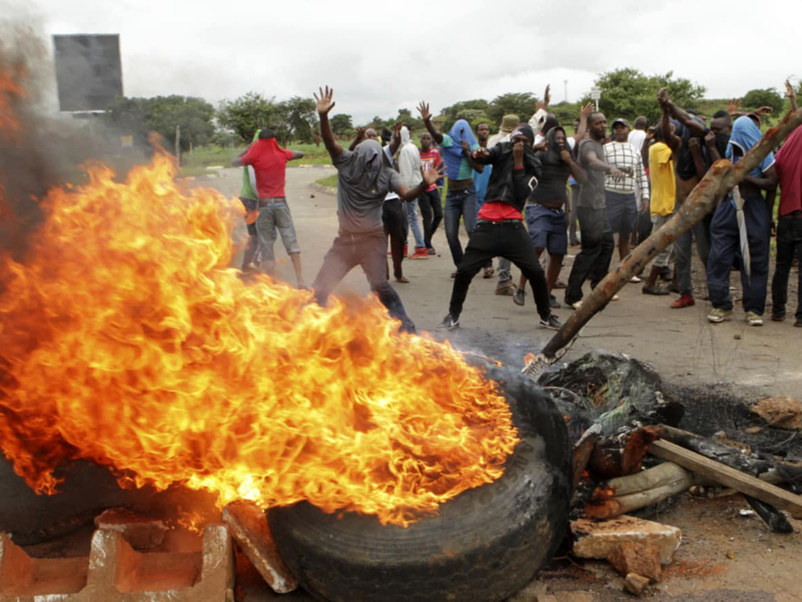 Protestors light fires during unrest in Zimbabwe